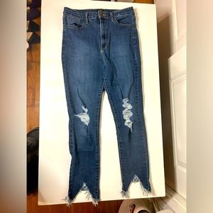 Denim jeans distressed with raw hemmed ankle seam size 30